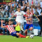 Real Madrid's Angel di Maria is fouled by Atletico Madrid's Raul Garcia