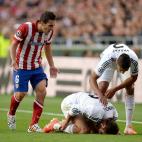 Atletico Madrid's Koke (left) checks on the condition of Real Madrid's Daniel Carvajal