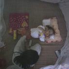 Nguyen Van Tuan Tu, de siete años, con serios problemas de salud, cuidado por un miembro de su familia cerca del aeropuerto de Danang. Su padre, ajeno al peligro, cogía peces del lago cercano para alimentar a su familia. El primer hijo del mat...