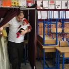 Un hombre sale de la caseta de voto secreto con sus bebé en brazos, uno de los 53 millones de turcos que podían votar en estas elecciones.