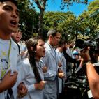 Opposition leader and self-proclaimed 'acting president' Juan Guaido (C), marches surrounded by students during a protest he convened against the government of President Nicolas Maduro, outside Venezuela's Central University (UCV) in Caracas, on...