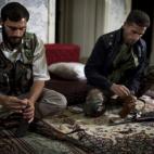 Combatientes de la oposición cargan sus AK-47 en el barrio de Saif Al-Dawla, en la ciudad de Alepo (Siria).