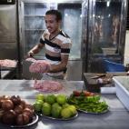 Mohammad, 23, prepara carne en un restaurante kebab en la ciudad de Alepo, Siria.