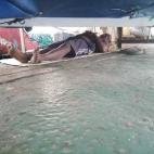 El sofocante calor les obligaba a dormir en la cubierta sobre una colchoneta.