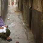 Buscando el fresco en la puerta de casa, en el campo de refugiados de Beach Camp.