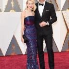 Ella, de Armani Privé. Él, de Burberry.