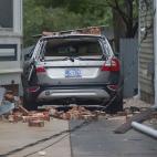 A car is destroyed from falling bricks as Hurricane Florence passes over Wilmington, North Carolina on September 14, 2018. - Florence smashed into the US East Coast Friday with howling winds, torrential rains and life-threatening storm surges as...