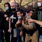 A person talks to a police officer during a demonstration against a political rally of far-right party Vox ahead of regional elections in Madrid's suburb of Vallecas on April 7, 2021. (Photo by JAVIER SORIANO / AFP) (Photo by JAVIER SORIANO/AFP ...