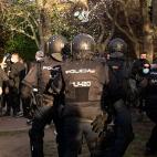 A can of beer is thrown to police during a demonstration against a political rally of far-right party Vox ahead of regional elections in Madrid's suburb of Vallecas on April 7, 2021. (Photo by JAVIER SORIANO / AFP) (Photo by JAVIER SORIANO/AFP v...