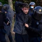 Police detain a person during a demonstration against a political rally of far-right party Vox ahead of regional elections in Madrid's suburb of Vallecas on April 7, 2021. (Photo by JAVIER SORIANO / AFP) (Photo by JAVIER SORIANO/AFP via Getty Images)