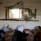 Un grupo de chicas haciendo el examen de fin de curso dentro de su colegio en la ciudad de Duma, en Damasco.