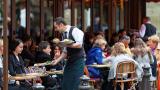 Paris, France - April 27, 2012: Waiter serving food in Cafe Le Bonaparte at Place Saint-Germain-des-Prés.