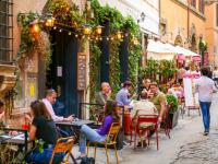 Rome, Italy, May 22 -- Some persons sitting outside a bar enjoy an aperitif in Trastevere in Rome during the slow reopening to a normal life after the lockdown due to the Covid-19. Image in HD format.