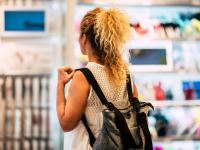 Una mujer, de espaldas, comprando en un centro comercial