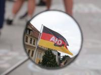 26 July 2026, Saxony-Anhalt, Weißenfels: A German flag bearing the AfD logo can be seen in the rearview mirror of a moped. AfD lead candidate Siegmund is on a campaign tour through Saxony-Anhalt ahead of the state election. Photo: Sebastian Willnow/dpa (Photo by Sebastian Willnow/picture alliance via Getty Images)