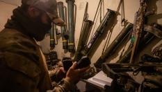 Un combatiente checheno revisa armamento en una posición de primera línea del frente.