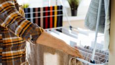 Una persona tendiendo su ropa en un tendedero