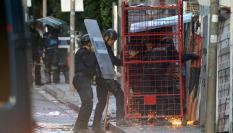 Los ocupas han lanzado sacos de escombros, botes de humo y bengalas para dificultar la intervención policial, en la que los Mossos han recurrido a una jaula metálica protectora para acceder.