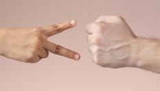 Dos personas jugando a piedra, papel o tijera.