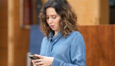 Foto de archivo de Ayuso con el teléfono móvil.