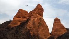 Imagen de un helicóptero de extinción sobrevolando el parque natural de Las Médulas (León), calcinado por los incendios del verano de 2025.
