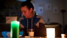 Una mujer ilumina su casa con velas durante el apagón
