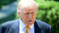 WASHINGTON, UNITED STATES - MAY 12: U.S. President Donald Trump speaks to members of the press before boarding Marine One on the South Lawn of the White House in Washington, United States, on May 12, 2026. (Photo by Kyle Mazza/Anadolu via Getty Images)