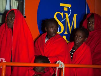 GRANADA, SPAIN - 2020/12/14: Sub-Saharan migrant children who were rescued from a dinghy at the Mediterranean Sea, are seen standing on a rescue boat with their children on their arrival at the Port of Motril. 
Un grupo de personas migrantes subsaharianas, entre ellas menores, a su llegada al puerto de Motril (Granada) tras ser rescatadas por Salvamento Marítimo, el 14 de diciembre de 2020.
