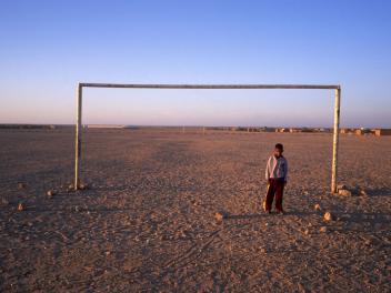 TINDOUF - MAY 5: A boy on the soccer field of the Sahrawi refugee camps located in Algerian territory since 1976, seen on May 5, 2002, Tindouf, Algeria (Photo by Xurxo Lobato / Getty Images)