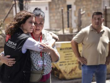 La presidenta de la Comunidad de Madrid, Isabel Díaz Ayuso (i), abraza a una afectada por los incendios en la urbanización El Encinar del Alberche, en Villa del Prado