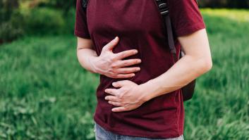 Persona tocándose el abdomen.