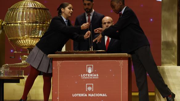 Samanta Fuster (i) y Ángel Abaga (d), los niños de la Residencia San Ildefonso del Ayuntamiento de Madrid encargados de cantar premio y número, respectivamente, de la primera tabla de del Sorteo Extraordinario de Navidad celebrado este lunes en el Teatro Real de Madrid.