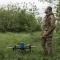 Un militar ucraniano prepara un dron en una zona boscosa