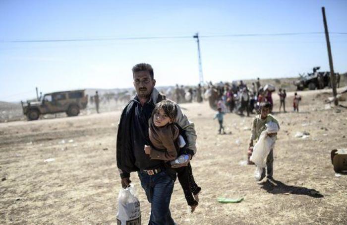 Las duras imágenes de 60.000 kurdos cruzando la frontera con Turquía (FOTOS)