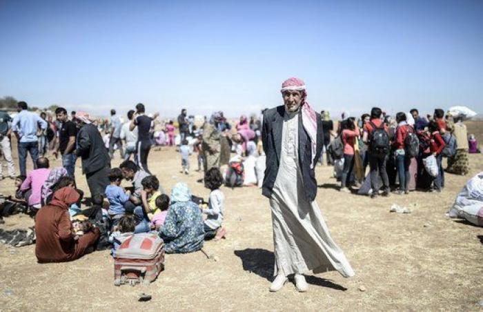 Las duras imágenes de 60.000 kurdos cruzando la frontera con Turquía (FOTOS)