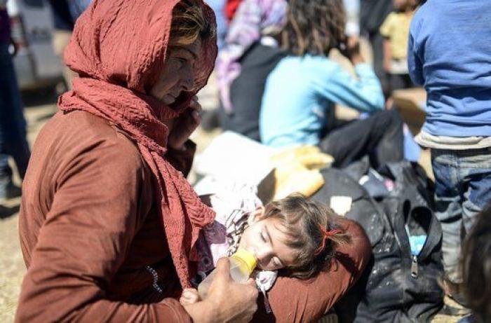 Las duras imágenes de 60.000 kurdos cruzando la frontera con Turquía (FOTOS)