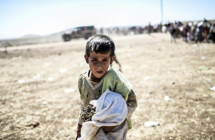 Las duras imágenes de 60.000 kurdos cruzando la frontera con Turquía (FOTOS)