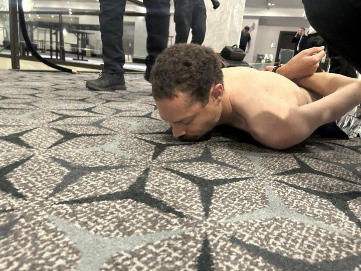 Law enforcement personnel detain Cole Tomas Allen, a suspect in the shooting incident at the White House Correspondents' Association dinner, in Washington, D.C., U.S. April 25, 2026. DONALD J TRUMP via Truth Social/Handout via REUTERS    THIS IMAGE HAS BEEN SUPPLIED BY A THIRD PARTY. MANDATORY CREDIT. REFILE - ADDING NAME OF THE SUSPECTED SHOOTER  VERIFICATION: Reuters was able to verify the location from flooring and windows that match corroborating footage. Date confirmed from the government statement of the incident. No old results were posted online before April 25. FBI confirmed that National Capital Response Squad has responded to a shooting at the Washington Hilton and added that the subject is in custody.