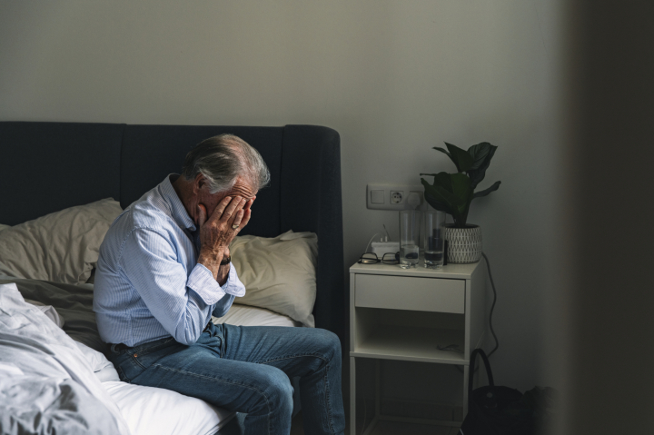 Un jubilado, con las manos en la cara, representando lamentación o preocupación