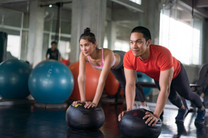 alt="alt="doing stretching exercises on fitness ball in gym.""