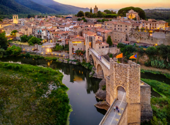 alt="alt="aerial view of the Medieval bridge of the Besalu at sunset. Catalonia, Spain""