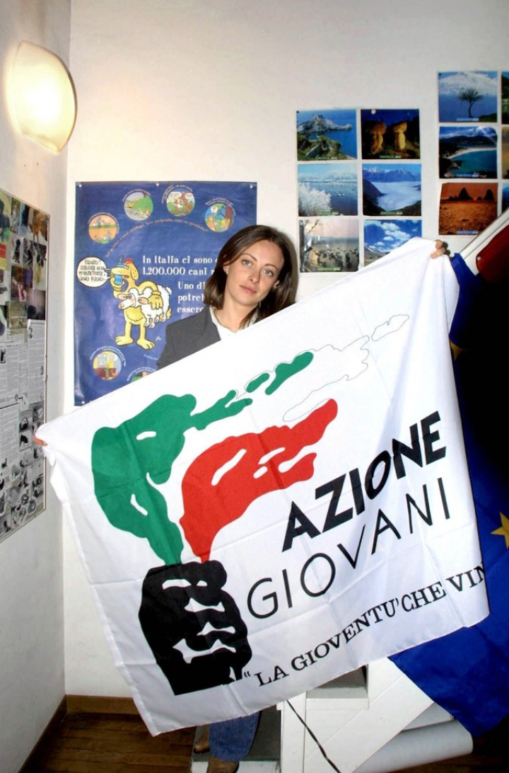 Una joven Giorgia Meloni, con la bandera de Azione Giovani.