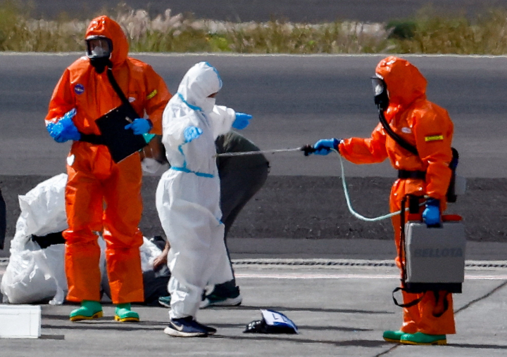 alt="alt="People wearing personal protective equipment make preparations on the tarmac at Tenerife Sud airport, following the arrival of the cruise ship MV Hondius, which was affected by a hantavirus outbreak, Canary Islands, Spain, May 10, 2026. REUTERS/Borja Suarez""