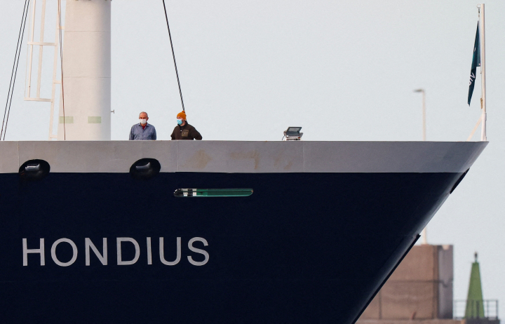alt="alt="People wearing masks stand aboard the cruise ship MV Hondius at the port of Granadilla de Abona, after being affected by a hantavirus outbreak, in Tenerife, Spain, May 10, 2026. REUTERS/Hannah McKay      TPX IMAGES OF THE DAY""