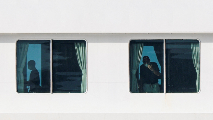 alt="alt="People aboard the cruise ship MV Hondius, which is affected by a hantavirus outbreak, at the port of Granadilla de Abona in Tenerife, Spain, May 10, 2026. REUTERS/Hannah McKay""