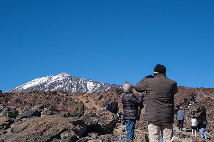 alt="alt="General views of the island of Tenerife. In the picture: tourists take pictures of the Teide volcano from the Minas de San Jose in Teide National Park, on January 13, 2026. (Photo by Stefano Nicoli/NurPhoto via Getty Images)""