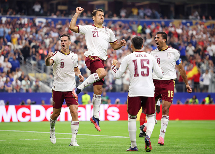ARLINGTON, TEXAS - JULY 14: Mikel Oyarzabal #21 of Spain celebrates with teammates after converting a penalty to score the team's first goal during the FIFA World Cup 2026 Semi Final match between France and Spain at Dallas Stadium on July 14, 2026 in Arlington, Texas. (Photo by Hector Vivas - FIFA/FIFA via Getty Images)