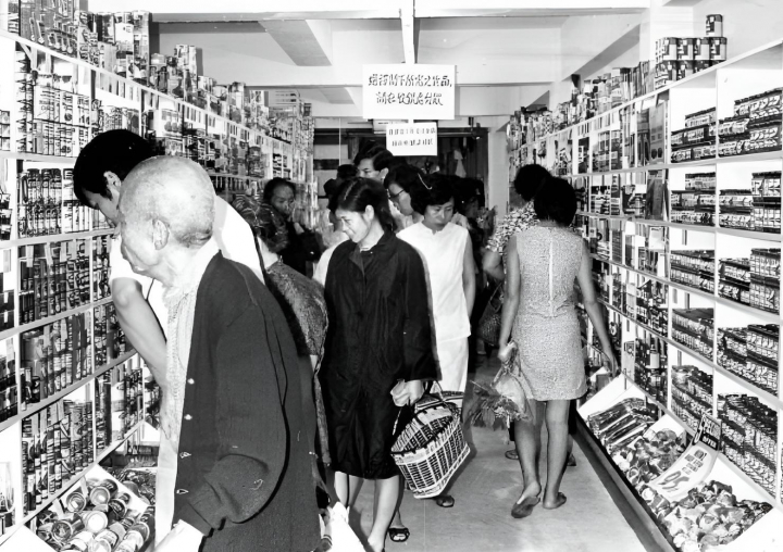 alt="alt="Varios clientes en un pasillo de un supermercado en la década de 1920""
