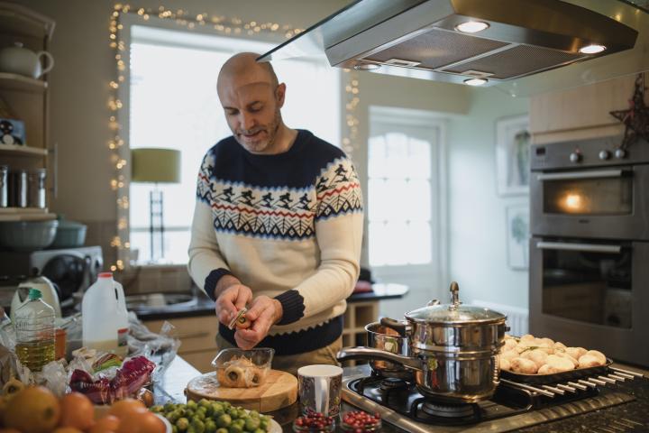 Un hombre cocinando en Navidad.
