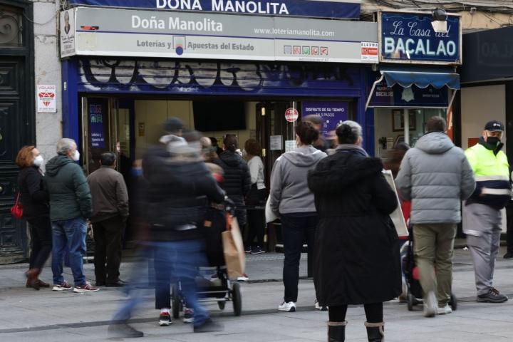 La gente espera en fila para comprar un décimo en la mítica tienda de Doña Manolita.